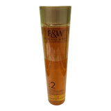 Clear bottle of Fair & White Gold 2 Unifier Even Tone Revitalizing Body Oil with Argan Oil, featuring a gold cap and amber-colored oil inside, photographed standing upright against a plain white background.