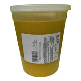 Large tub of yellow African shea butter with a clear plastic lid and a white product label featuring a barcode, handling instructions, and the text “Shea Butter (Large)” priced at $17.99.